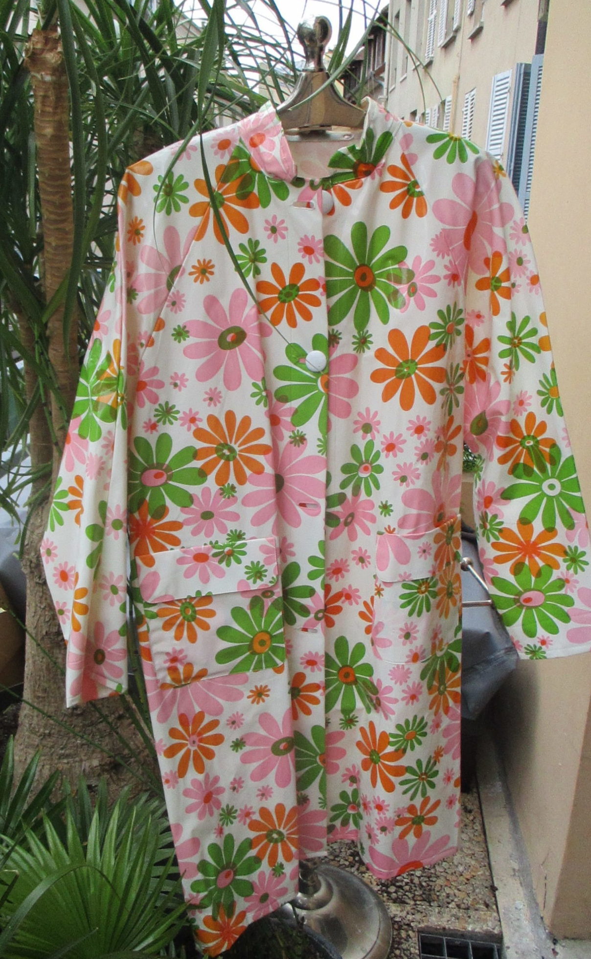 THE raincoat 1960s raincoat in pink , green and white SOLD
